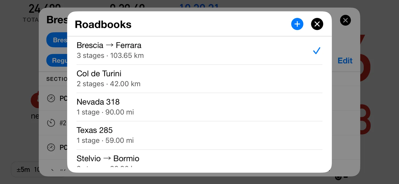 The Roadbooks library listing four books: Brescia → Ferrara, 3 stages · 103.65 km, ticked as active; Col de Turini, 2 stages · 42.00 km; Nevada 318, 1 stage · 90.00 mi; and Texas 285, 1 stage · 59.00 mi. A + button sits in the header beside the close button.